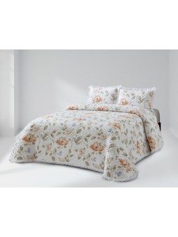 Colcha lencera con volante en tonos beige y nude.