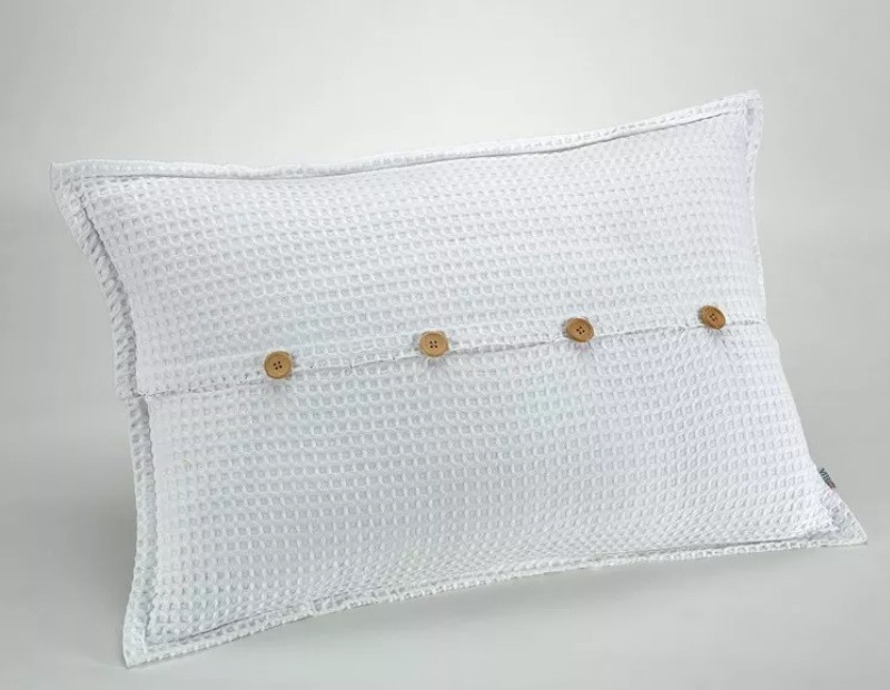 Funda de cojín de nido de abeja waffle en color blanco con diseño de botones madera.