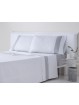 Juego de sábanas en color blanco con gris de tejido de algodón de gran calidad. Estilo lencero.